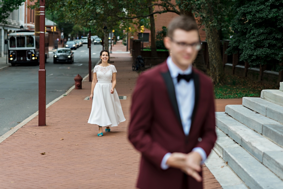 A bride walking up to her groom during their first look.